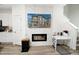 Elegant living room featuring a modern fireplace, TV, and a sleek workspace for added convenience at 8376 Lorenzo Ln # A, Highlands Ranch, CO 80129