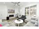Bright living room with stylish furnishings, a fireplace with TV above, and large windows for natural light at 8376 Lorenzo Ln # A, Highlands Ranch, CO 80129