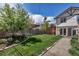 This backyard offers a well-maintained lawn, wood fence, tasteful landscaping, and a patio at 1250 S Vine St, Denver, CO 80210