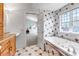 Marble bathroom with tub and walk-through doorway at 1250 S Vine St, Denver, CO 80210
