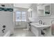 Bright bathroom with double sinks, decorative tile, and a shower/tub combination at 1250 S Vine St, Denver, CO 80210
