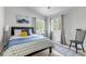 Comfortable bedroom featuring a bed, a decorative rug, and two windows with bright natural light at 1250 S Vine St, Denver, CO 80210