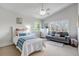 Cozy bedroom with two windows offering abundant sunlight, a bed, and a sitting area at 1250 S Vine St, Denver, CO 80210