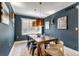 Traditional dining room featuring a wooden table, modern art, and designer lighting at 1250 S Vine St, Denver, CO 80210