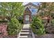 Charming Tudor-style home with a brick facade, lush landscaping, and inviting front entrance at 1250 S Vine St, Denver, CO 80210