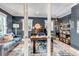 Inviting home office with hardwood floors, blue walls, natural light, built-in bookcase and grand piano at 1250 S Vine St, Denver, CO 80210