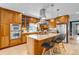 A chef's kitchen with stainless steel appliances, granite countertops, and a central island with seating at 1250 S Vine St, Denver, CO 80210