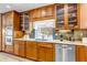A well-lit kitchen with wood cabinets, granite countertops, stainless steel appliances, and a window with a view at 1250 S Vine St, Denver, CO 80210