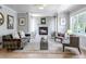 Bright living room featuring a fireplace, neutral decor, and large windows at 1250 S Vine St, Denver, CO 80210