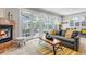 Cozy living room with a fireplace, comfortable seating, and large windows offering plenty of natural light at 1250 S Vine St, Denver, CO 80210