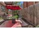 Outdoor area with a stylish red umbrella, comfortable chairs, and a decorative rug, perfect for lounging at 1250 S Vine St, Denver, CO 80210