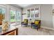Bright sitting area with two chairs, large windows, and a view of the well-kept backyard at 1250 S Vine St, Denver, CO 80210
