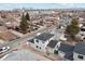 Aerial view of a two-story house with gray siding, dark roof, and attached garage at 3224 W Dakota Ave, Denver, CO 80219