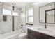 Bathroom featuring marble-tiled shower and tub, a modern sink, and a window at 3224 W Dakota Ave, Denver, CO 80219