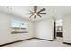 Bright bedroom featuring a modern ceiling fan, hardwood floors, and natural light from large windows at 3224 W Dakota Ave, Denver, CO 80219