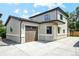 Inviting two-story home featuring a concrete driveway and an attached garage with automatic door at 3224 W Dakota Ave, Denver, CO 80219