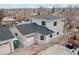 Side view of a two-story house with gray siding, dark roof, and attached garage at 3224 W Dakota Ave, Denver, CO 80219