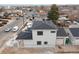 Rear view of two-story house with gray siding, dark roof, and attached garage at 3224 W Dakota Ave, Denver, CO 80219