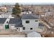 Side view of a two story house with gray siding, dark roof, and attached garage at 3224 W Dakota Ave, Denver, CO 80219