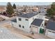 Two-story house with gray siding, dark roof, attached garage, and backyard at 3224 W Dakota Ave, Denver, CO 80219