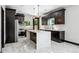 Modern kitchen with stainless steel appliances, marble counters and backsplash, and dark wood cabinets at 3224 W Dakota Ave, Denver, CO 80219