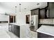Contemporary open concept kitchen with a large quartz island, stainless steel appliances, and recessed lighting at 3224 W Dakota Ave, Denver, CO 80219