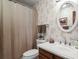 Bathroom features floral wallpaper, a vanity, and a shower with a curtain at 9161 W Hialeah Pl, Littleton, CO 80123