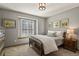 Bedroom featuring neutral tones, carpeted floors, and a bright window at 9161 W Hialeah Pl, Littleton, CO 80123