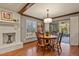 Bright dining area with hardwood floors and a view of the sunroom at 9161 W Hialeah Pl, Littleton, CO 80123