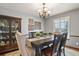 Dining room features a chandelier, decorative wall art, and hardwood floors at 9161 W Hialeah Pl, Littleton, CO 80123