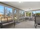 Sunroom filled with lots of natural light and seating at 9161 W Hialeah Pl, Littleton, CO 80123