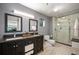 Modern bathroom features a double vanity, glass shower, and contemporary fixtures at 930 Acoma St # 106, Denver, CO 80204