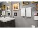 Stylish half bathroom with modern sink vanity and framed artwork adding to the space's charm at 930 Acoma St # 106, Denver, CO 80204