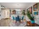 Dining area near kitchen with lots of art, open to other living spaces, with modern light fixture at 930 Acoma St # 106, Denver, CO 80204
