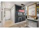 Hallway entrance to the kitchen with decorative mirror, art, and overhead lighting at 930 Acoma St # 106, Denver, CO 80204