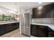 Well-lit kitchen showcasing stainless steel appliances, dark cabinets, and open layout design at 930 Acoma St # 106, Denver, CO 80204