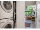Convenient laundry closet with stacked washer and dryer adjacent to a lovely living space at 930 Acoma St # 106, Denver, CO 80204