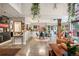 Large living area with open floor plan, dining area, modern decor, plants and kitchen access at 930 Acoma St # 106, Denver, CO 80204