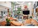 Bright living room featuring large windows, tan leather furniture, modern decor, and vibrant plants at 930 Acoma St # 106, Denver, CO 80204