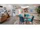 Bright and airy living space flowing into the kitchen, decorated with unique art and modern fixtures at 930 Acoma St # 106, Denver, CO 80204