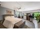 Spacious bedroom features gray walls, stylish furnishings, and ample natural light from the many windows at 930 Acoma St # 106, Denver, CO 80204