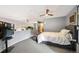 Contemporary main bedroom featuring gray walls, modern ceiling fan, and a stylish bed with a gray tufted bench at 930 Acoma St # 106, Denver, CO 80204