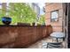 Charming patio with brick facade, potted plants, and outdoor seating area at 930 Acoma St # 106, Denver, CO 80204