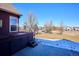 Backyard featuring a hot tub, concrete patio, and large grassy area, perfect for outdoor enjoyment at 5107 Appleton Way, Castle Rock, CO 80104