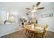 Open concept dining room with kitchen view, wood table, and ceiling fan at 7251 S Xenia Cir # F, Centennial, CO 80112