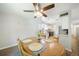 Bright dining room with wood table and chairs, ceiling fan, and view into kitchen at 7251 S Xenia Cir # F, Centennial, CO 80112