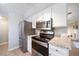 Stainless steel appliances and granite countertops in this updated kitchen at 7251 S Xenia Cir # F, Centennial, CO 80112