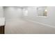 Spacious carpeted basement area with two windows and neutral paint throughout at 2515 N Gaylord St, Denver, CO 80205