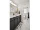 Modern bathroom featuring marble floors, granite countertops, and a gold-trimmed mirror at 2515 N Gaylord St, Denver, CO 80205