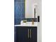 Stylish bathroom featuring blue tile, a modern vanity, and gold fixtures at 2515 N Gaylord St, Denver, CO 80205